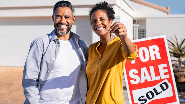 couple looking at sold house