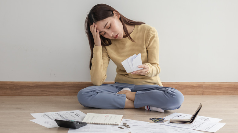 woman surrounded by bills