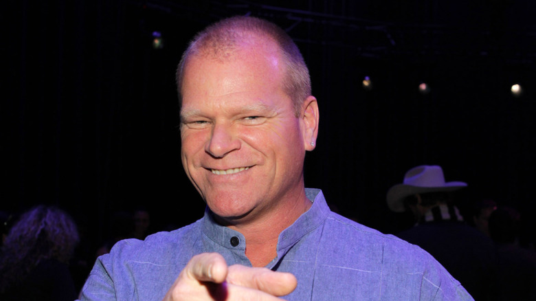 HGTV's Mike Holmes smiling and pointing at an event