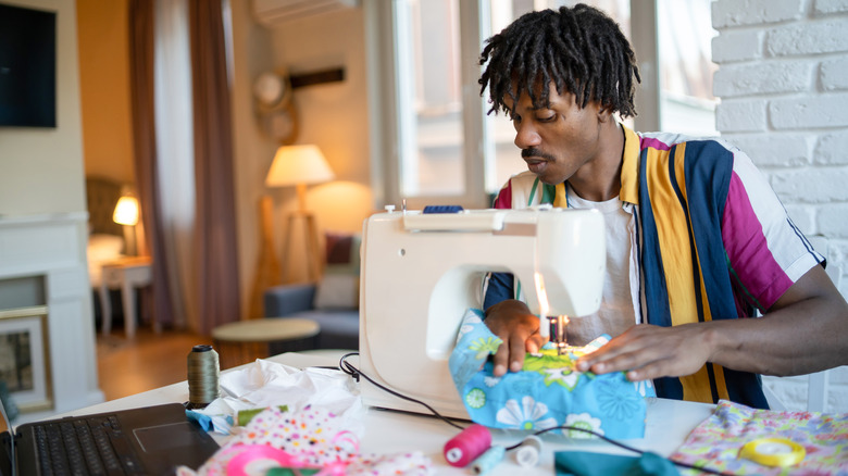 man using sewing machine