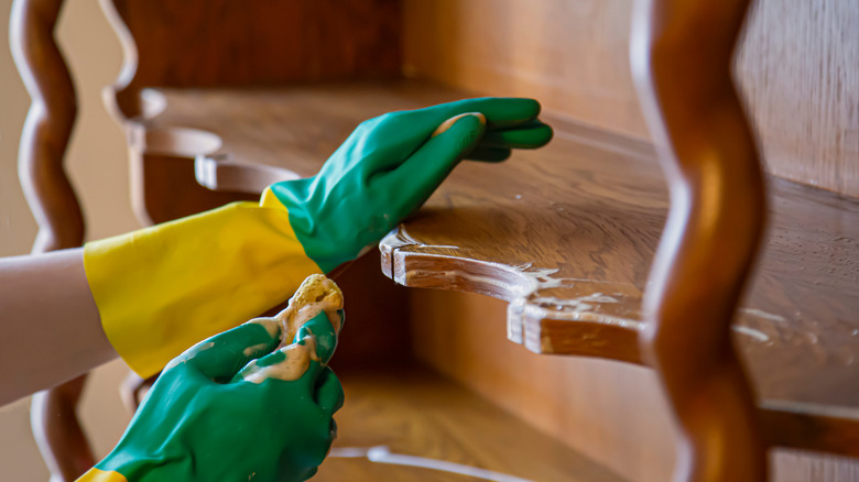 Person cleaning vintage furniture