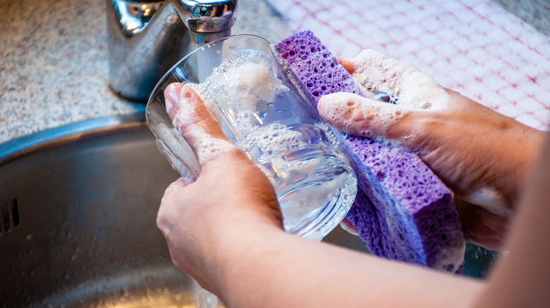 Person cleaning a glass