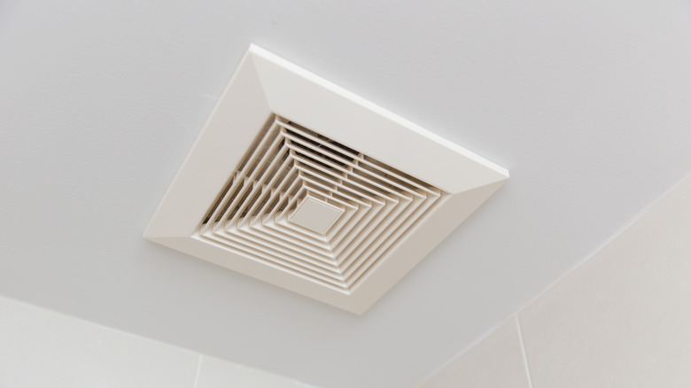 A clean bathroom fan on the ceiling