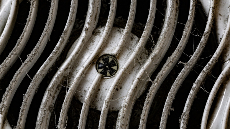 A dirty bathroom fan in the ceiling