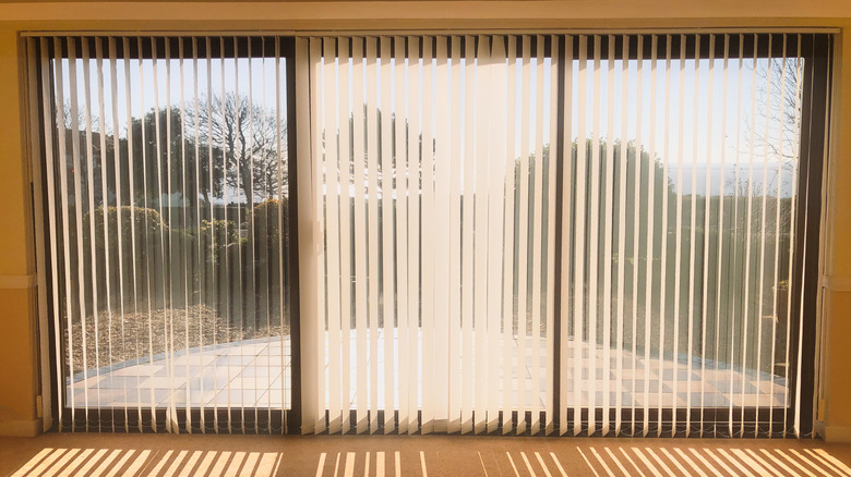 three windows with vertical blinds