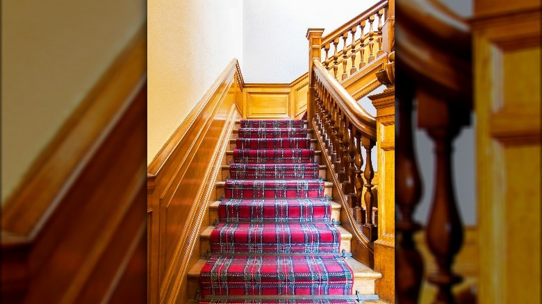 Wood stairs with plaid runner