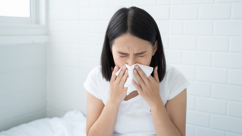 Woman sneezing