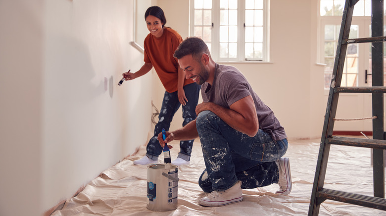 couple painting chalk wall