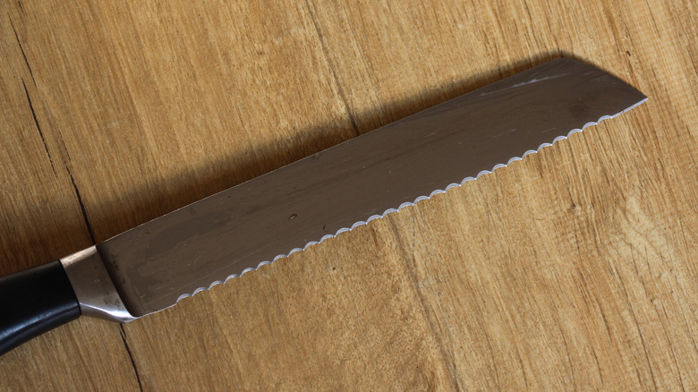 Serrated knife on wooden table