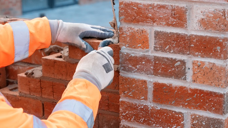 Person installing brick
