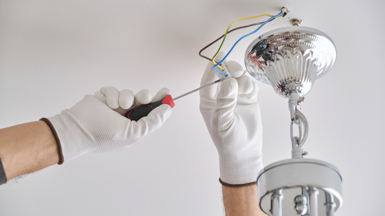 Person installing new light fixture