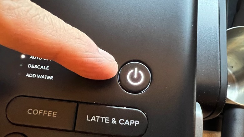 Finger near Keurig power button