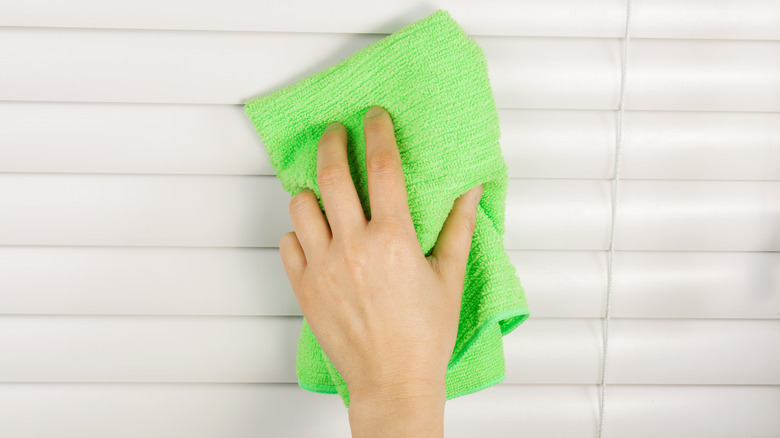 Cleaning blinds with cloth