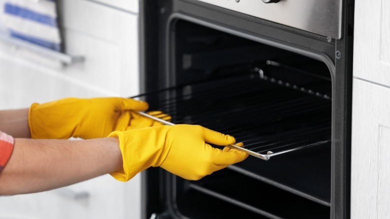 Woman with gloves removing racks