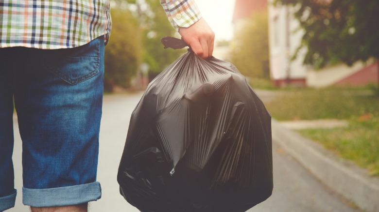 Woman taking trash outside 