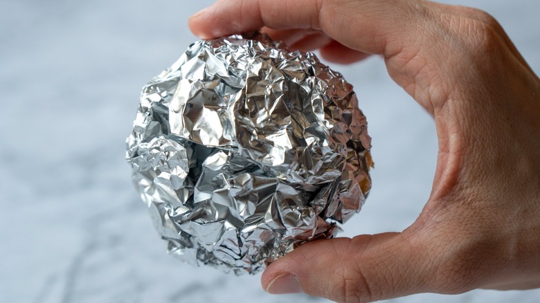 Person holding foil ball 
