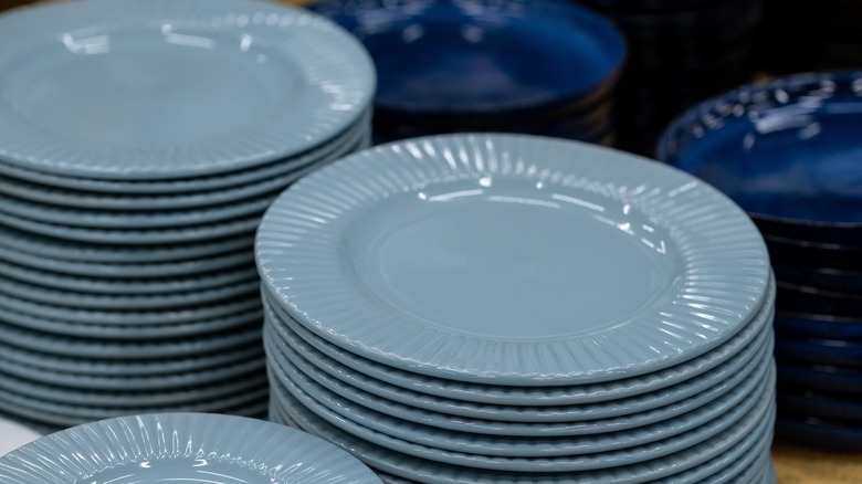 five stacks of plain gray and blue ceramic plates