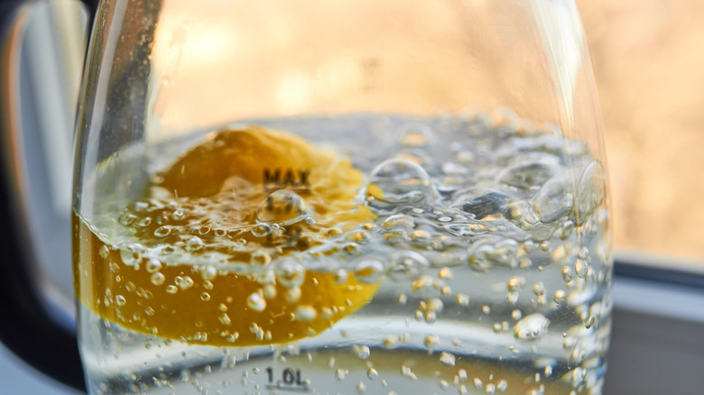 Lemon half boiling in water