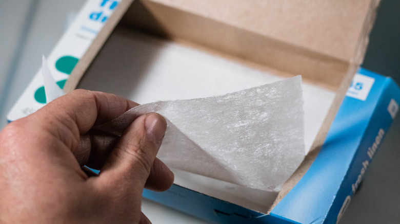 Taking dryer sheet from box