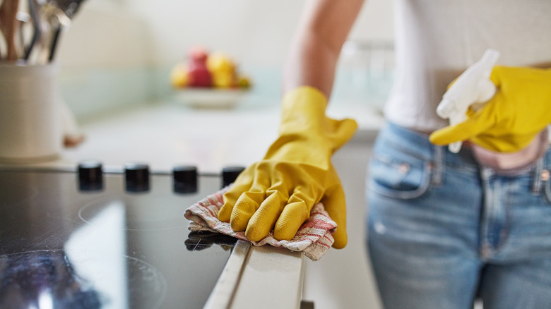 woman cleaning stove 