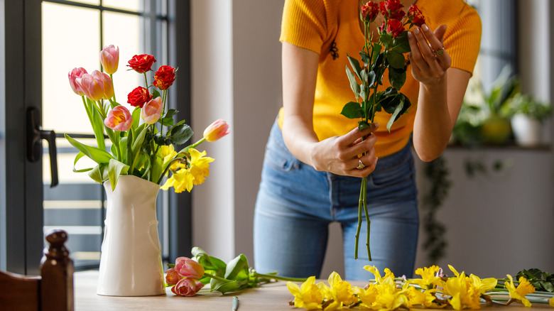 person holding cut flowers bouquet