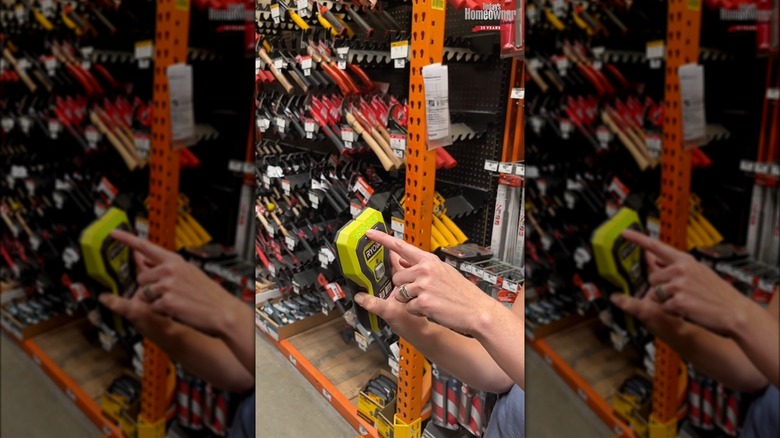 woman holding Ryobi stud finder