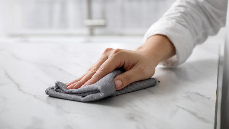 hand wiping countertop