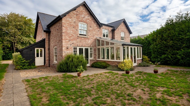 Brick house with patchy lawn