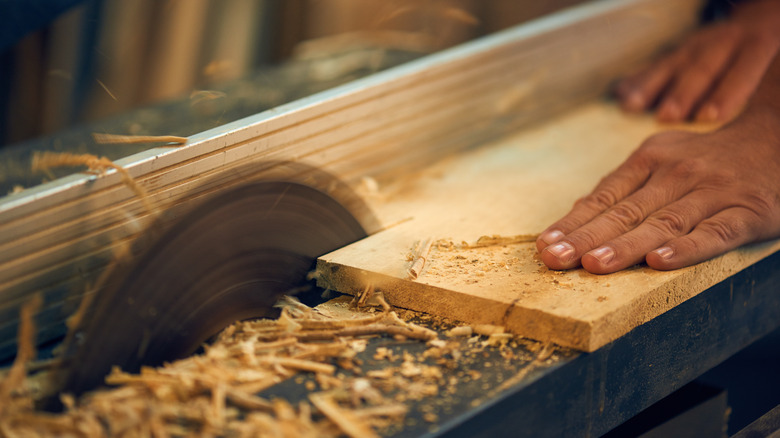 person cutting wood