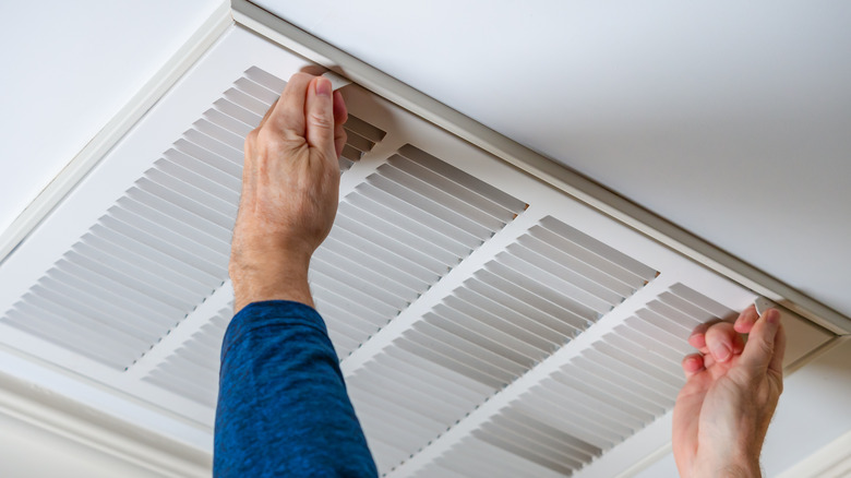 Someone checking an HVAC vent