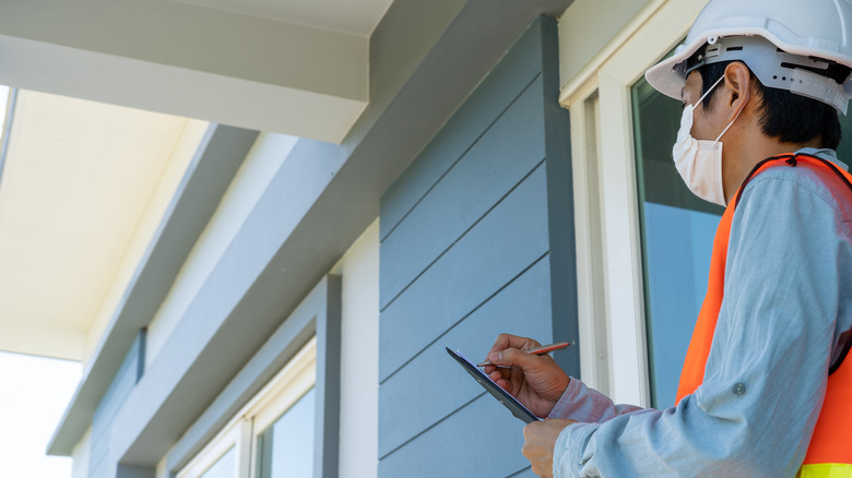 A home inspector taking notes