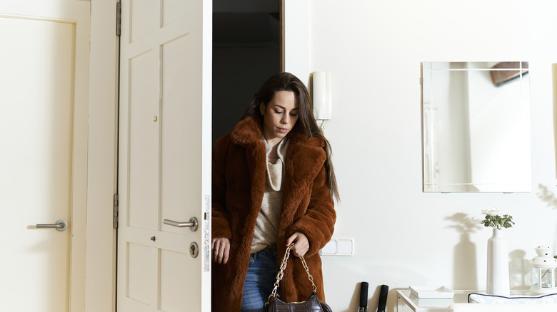 Woman stepping into her white-themed entry