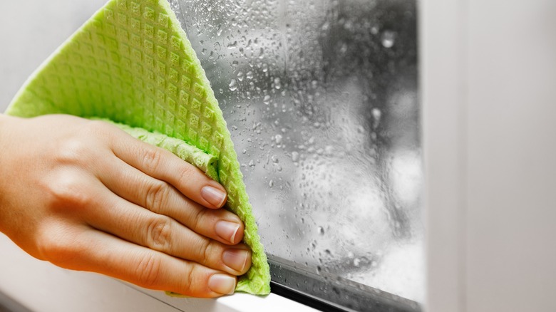 wiping window with rag 