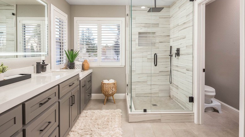 bathroom with grey walls and dark grey cabinets