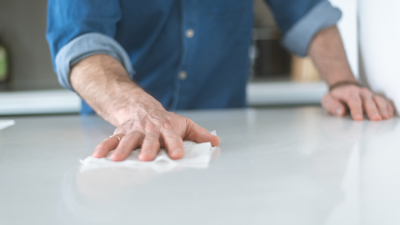 Man wiping kitchen counter