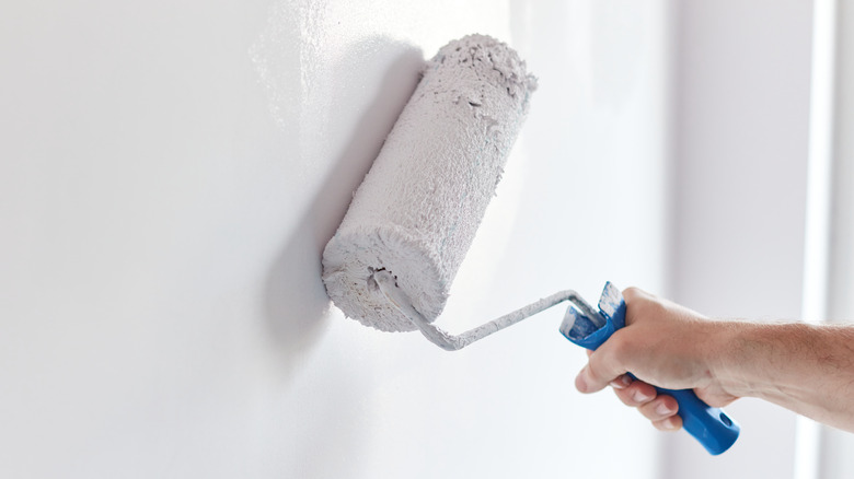 Hand holding paint roller