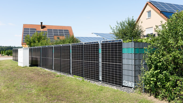 Houses with solar panels surrounded by a solar fence