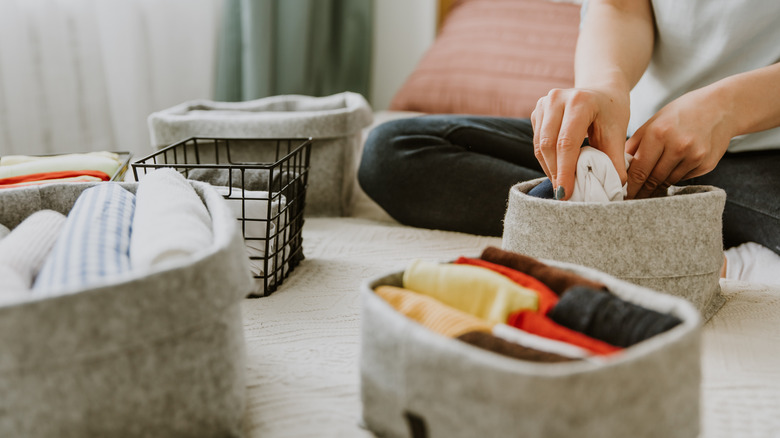 Person organizing items in bedroom