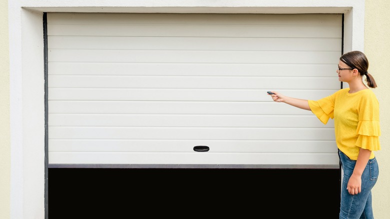 Woman opening garage door