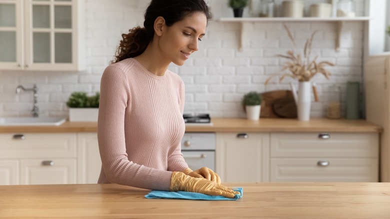 Woman cleaning kitchen counter