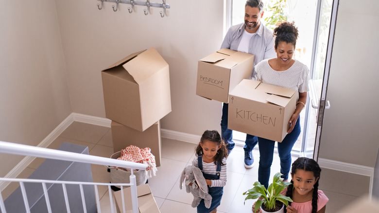 family moves boxes into home