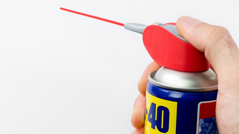 Hand spraying WD-40