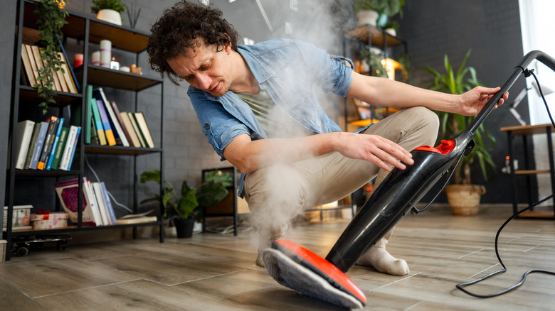 Man looks skeptically at steam cleaner