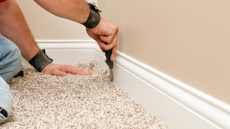 Person installing carpet