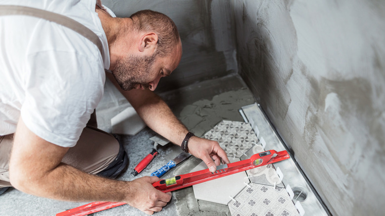 professional laying patterned tiles