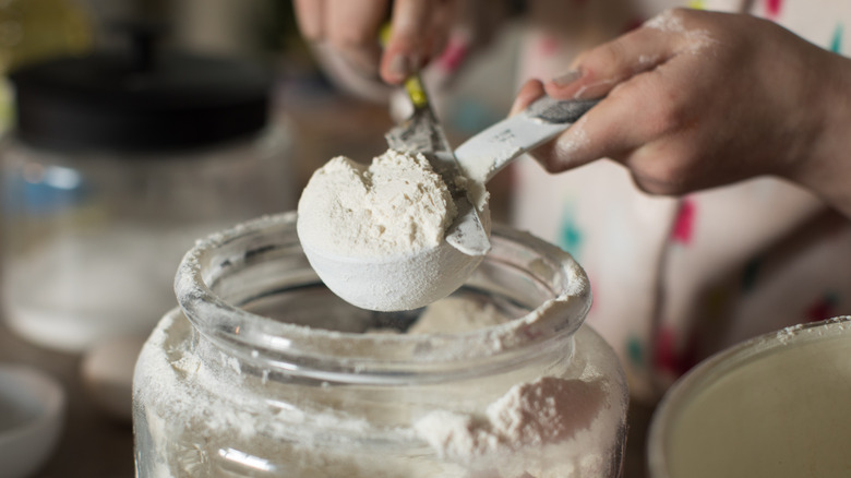 Person measuring out flour