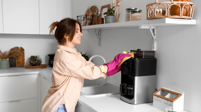 Woman wiping down appliance
