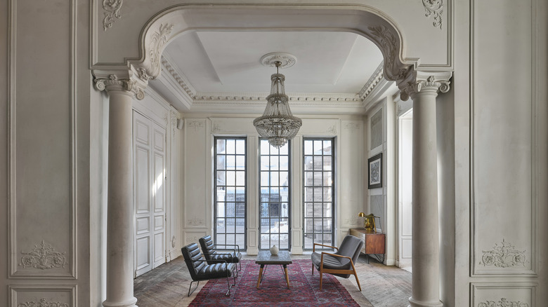 Victorian-inspired entryway with modern table and chairs