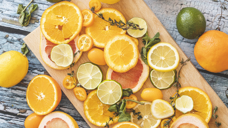 citrus fruits on cutting board 