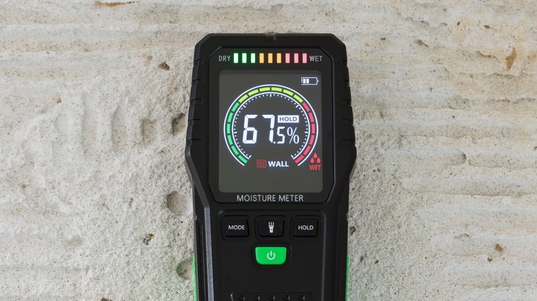 A pinless moisture meter on wall